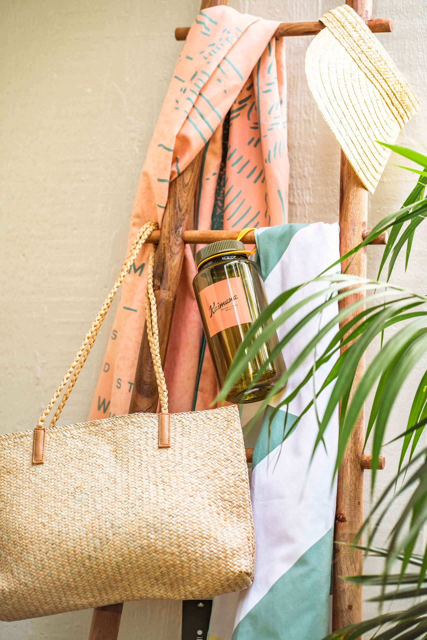 A wicker tote hangs from a wooden display rack