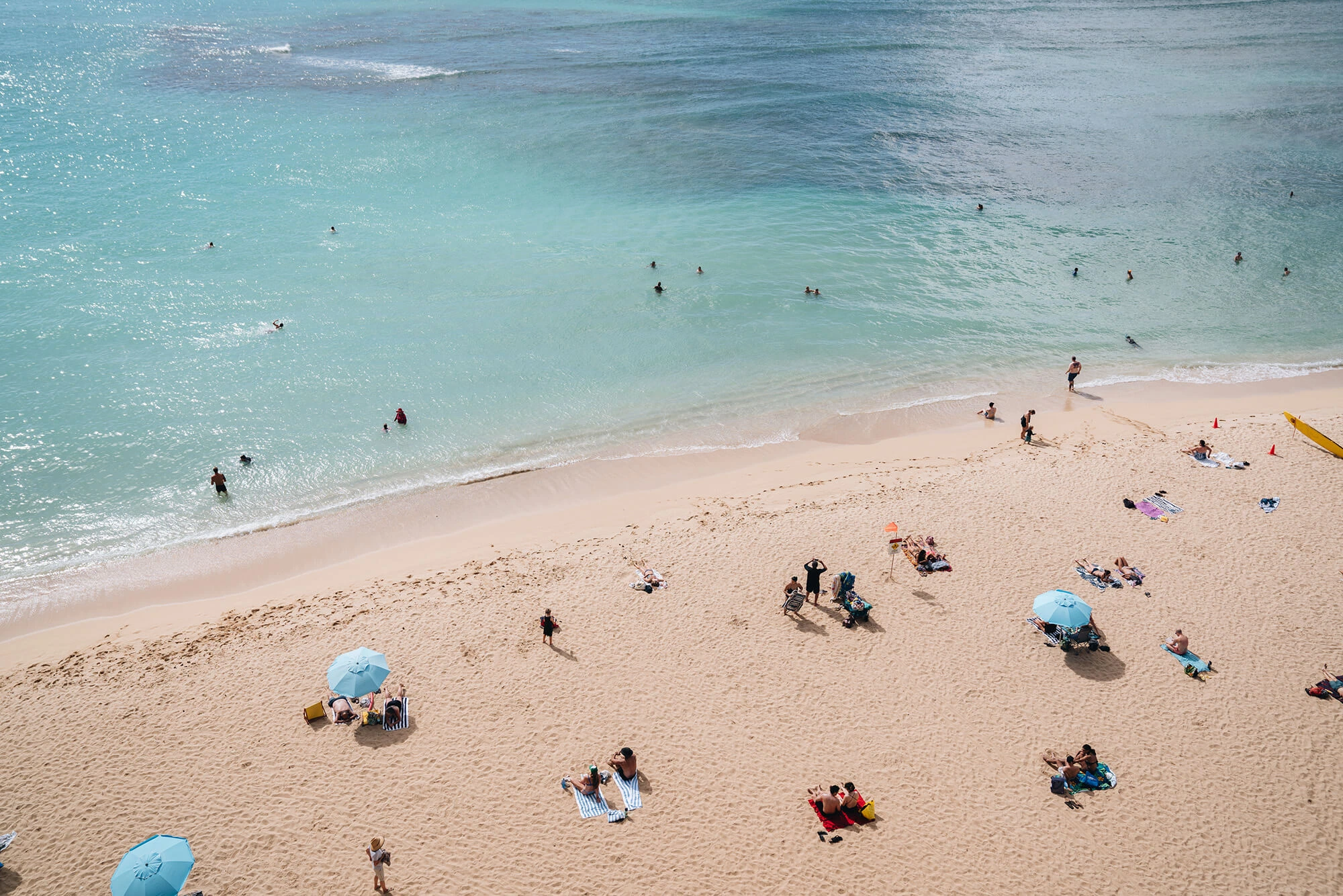 Kaimana guests enjoying the white sand beach