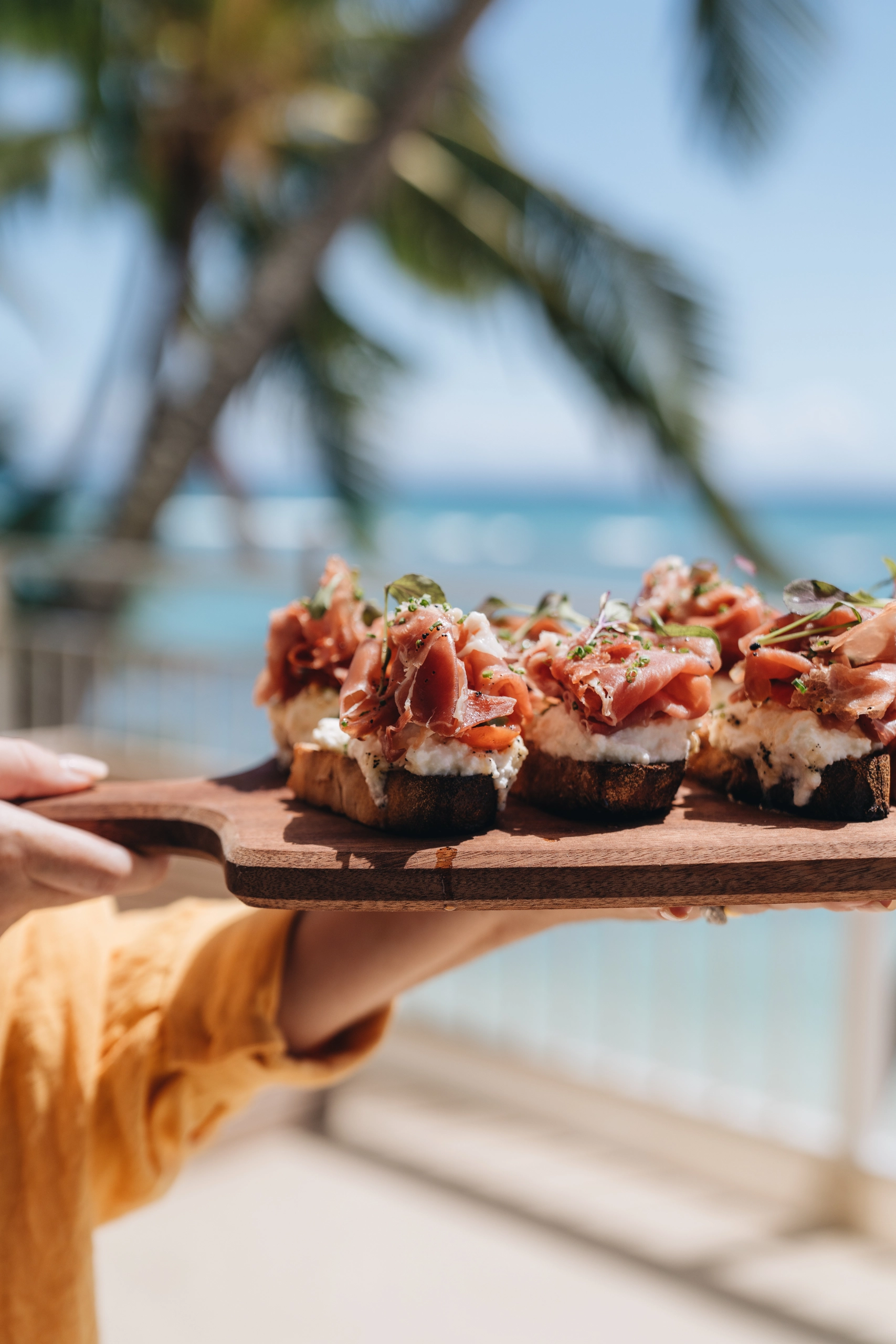 A wooden tray of bruschetta
